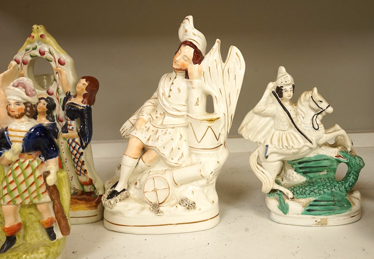 A collection of Staffordshire figures, mostly flatback to include a pocket watch holder, largest 37cm high